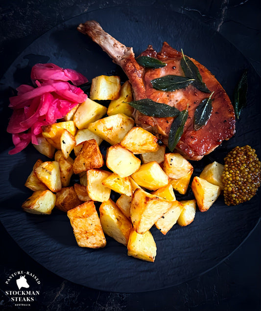 Rustic pork cutlets with sage, roast potatoes, and pickled onions